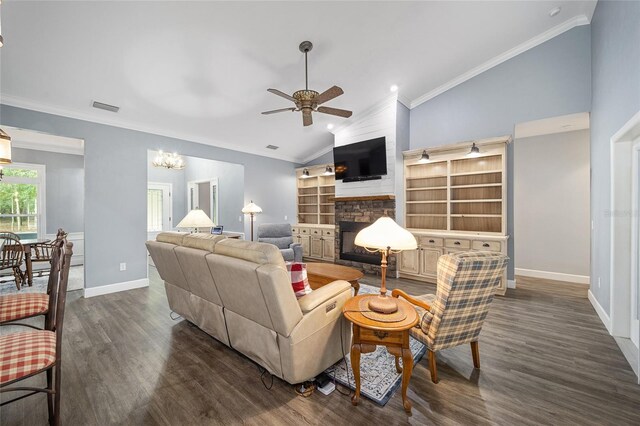 living room featuring ornamental molding, a large fireplace, dark hardwood / wood-style floors, and ceiling fan with notable chandelier