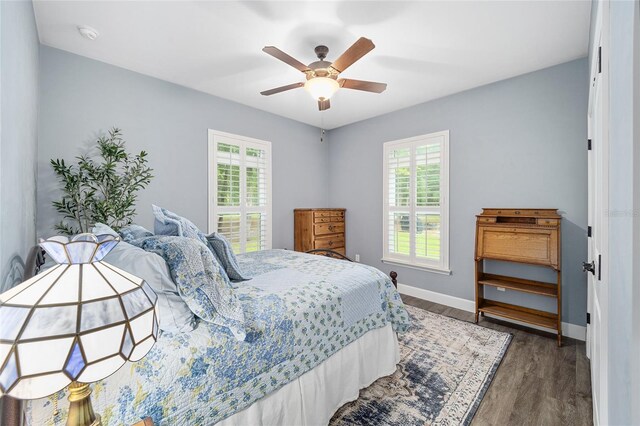 bedroom with dark wood-type flooring and ceiling fan