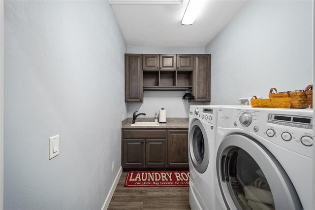 clothes washing area with dark hardwood / wood-style flooring, cabinets, washing machine and clothes dryer, and sink