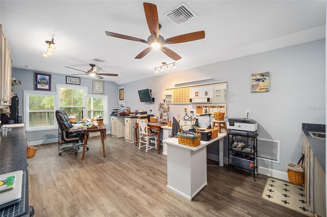 home office with hardwood / wood-style floors and ceiling fan