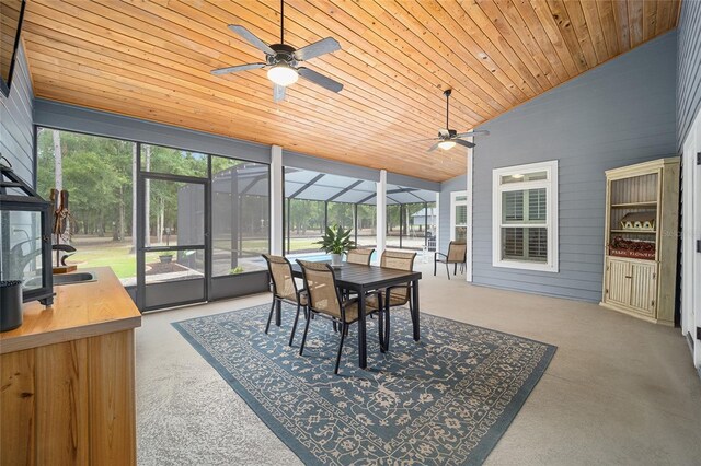 sunroom / solarium with lofted ceiling, a healthy amount of sunlight, and ceiling fan