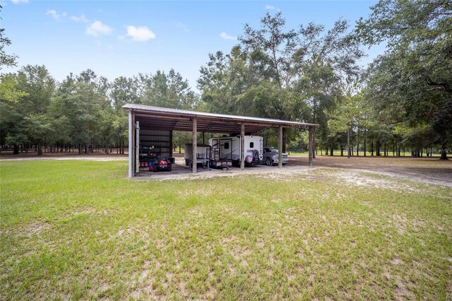 view of parking with a yard and a carport