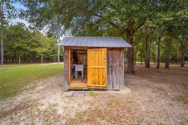 view of outbuilding with a lawn