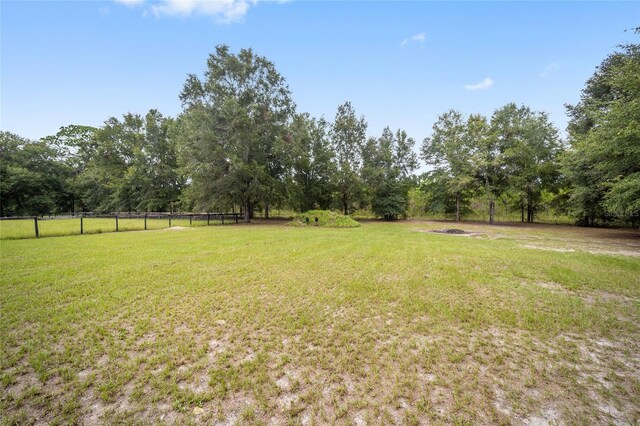 view of yard with a rural view