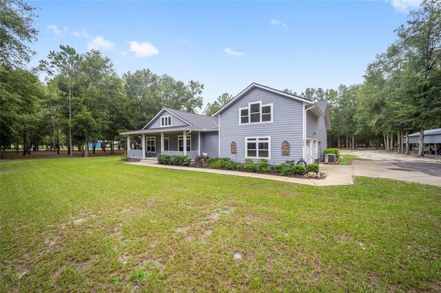 view of front property featuring central AC, a front lawn, and a porch