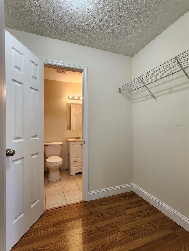 walk in closet with wood-type flooring