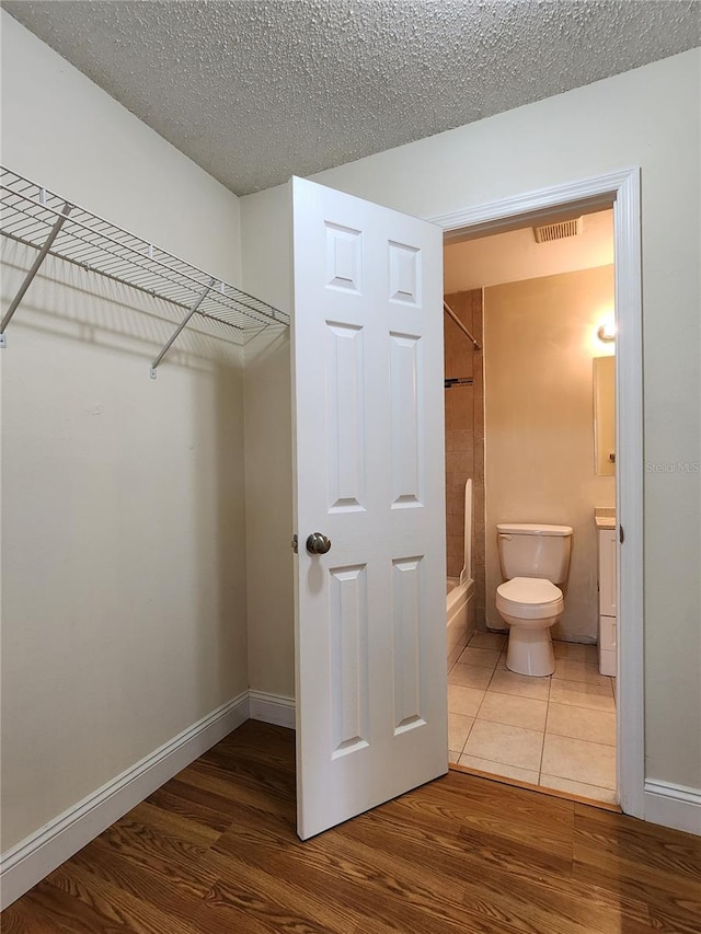 spacious closet featuring hardwood / wood-style flooring