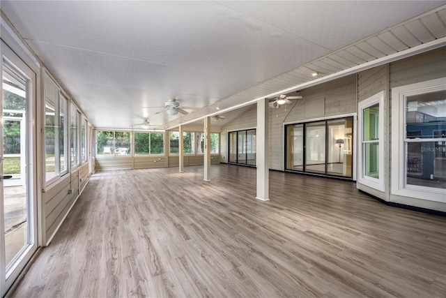 unfurnished sunroom with ceiling fan