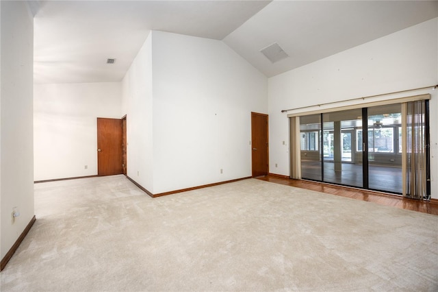 empty room featuring lofted ceiling and light hardwood / wood-style flooring