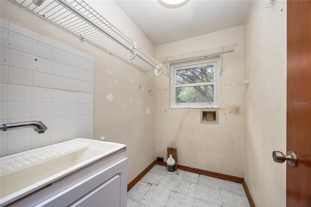 clothes washing area featuring hookup for a washing machine and light tile patterned floors