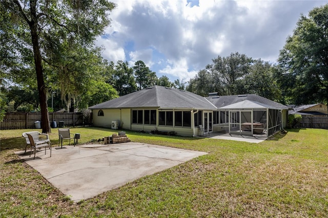 back of property featuring a sunroom, a yard, and a patio area