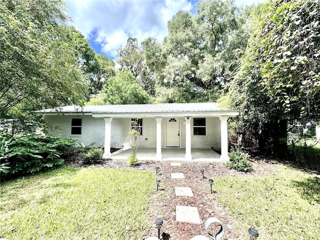 single story home with a front yard and brick siding