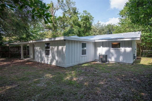 520 SE 5th St, Williston, FL 32696 - rear view of house featuring cooling unit, board and batten siding, fence, and metal roof