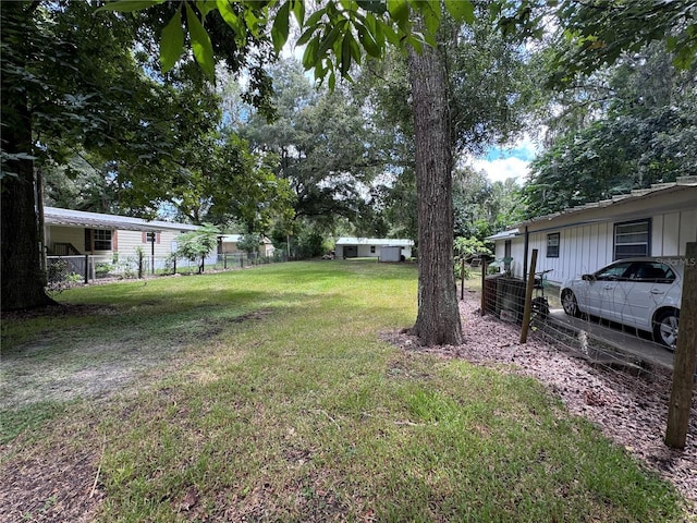 520 SE 5th St, Williston, FL 32696 - view of yard featuring an outbuilding and fence