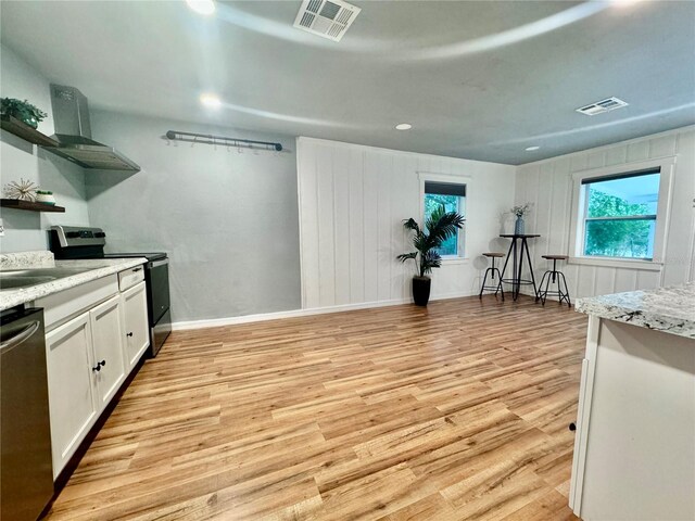 kitchen with white cabinetry, ventilation hood, sink, appliances with stainless steel finishes, and light hardwood / wood-style floors