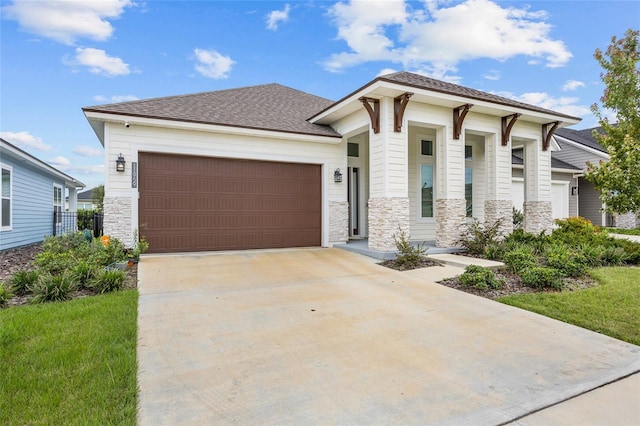 view of front of property featuring a garage and a front yard