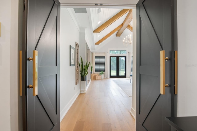 corridor featuring french doors, light wood-type flooring, beam ceiling, high vaulted ceiling, and a notable chandelier