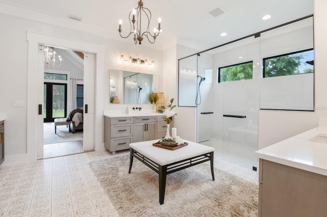 bathroom featuring an inviting chandelier, tile patterned flooring, walk in shower, and vanity