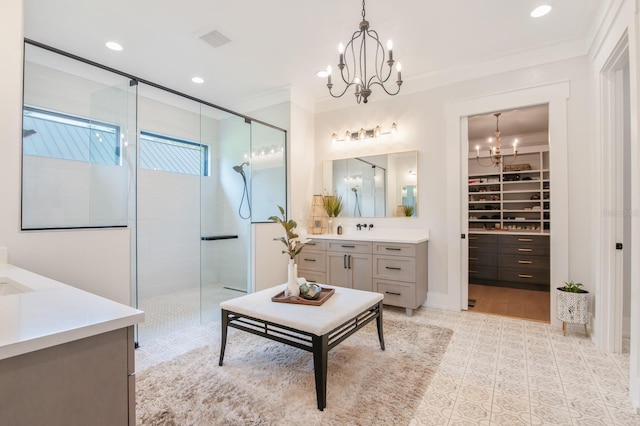 bathroom with vanity, walk in shower, an inviting chandelier, and ornamental molding