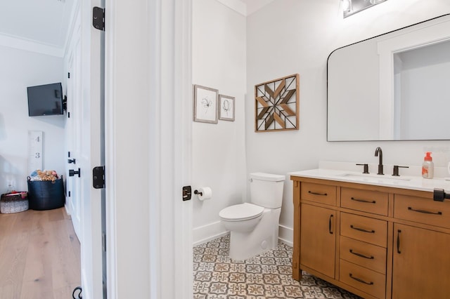 bathroom featuring crown molding, toilet, and vanity