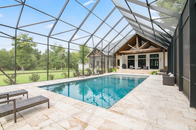 view of swimming pool featuring a lanai and a patio