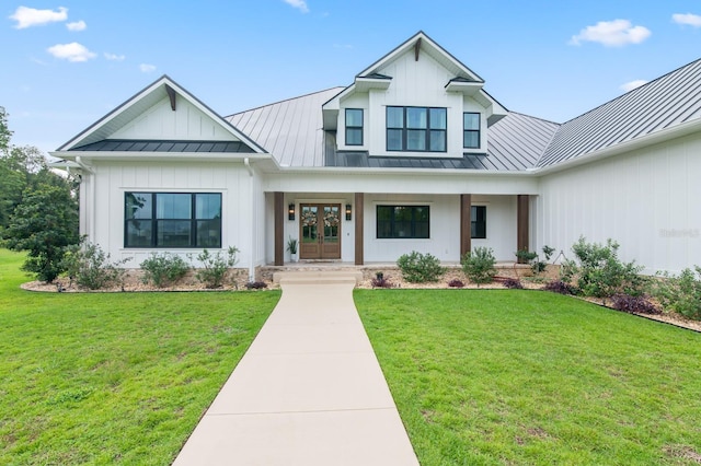 modern farmhouse with french doors and a front lawn