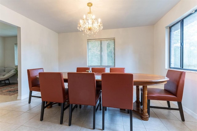 tiled dining space with a notable chandelier