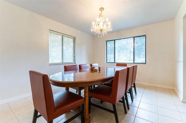 tiled dining area featuring a healthy amount of sunlight and a chandelier