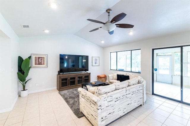 living room with ceiling fan, light tile patterned flooring, and vaulted ceiling