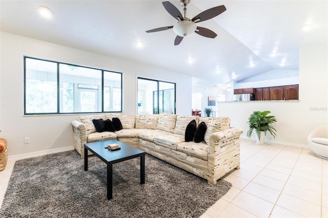 living room featuring ceiling fan, light tile patterned flooring, and lofted ceiling