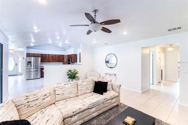 living room with ceiling fan, light tile patterned floors, and lofted ceiling