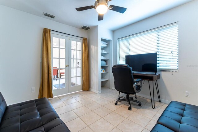 office space with built in shelves, light tile patterned floors, french doors, and ceiling fan