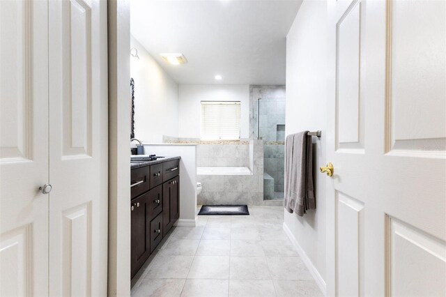 full bathroom with tile patterned flooring, vanity, toilet, and independent shower and bath