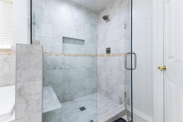 bathroom featuring a shower with shower door