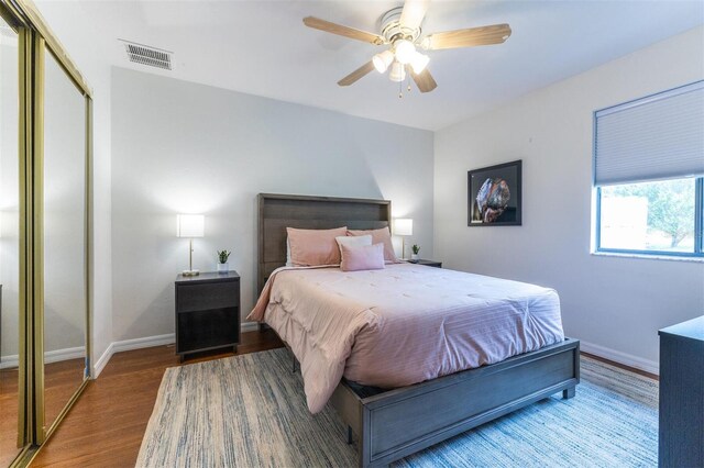 bedroom with ceiling fan, a closet, and hardwood / wood-style flooring