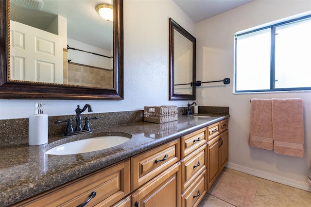 bathroom with tile patterned flooring and vanity