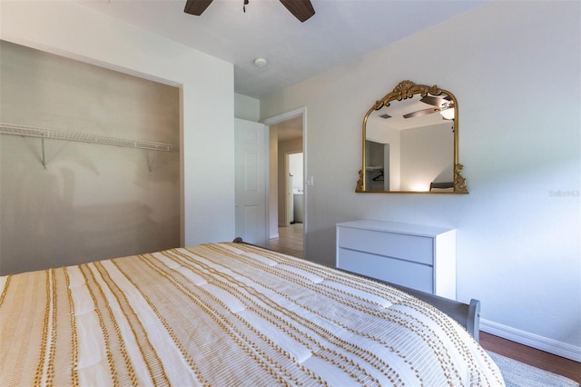 unfurnished bedroom featuring hardwood / wood-style flooring, ceiling fan, and a closet