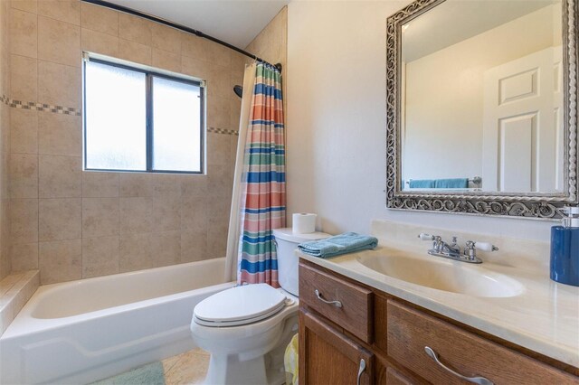 full bathroom featuring tile patterned flooring, vanity, toilet, and shower / bathtub combination with curtain