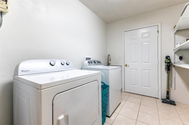 washroom featuring separate washer and dryer and light tile patterned floors