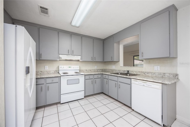 kitchen featuring gray cabinets, white appliances, sink, and light tile patterned flooring