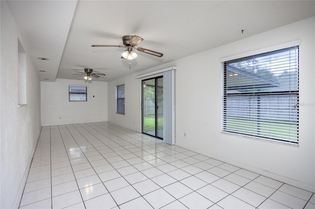 tiled empty room featuring ceiling fan