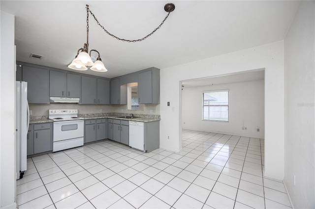 kitchen with gray cabinets, white appliances, light tile patterned floors, decorative light fixtures, and an inviting chandelier