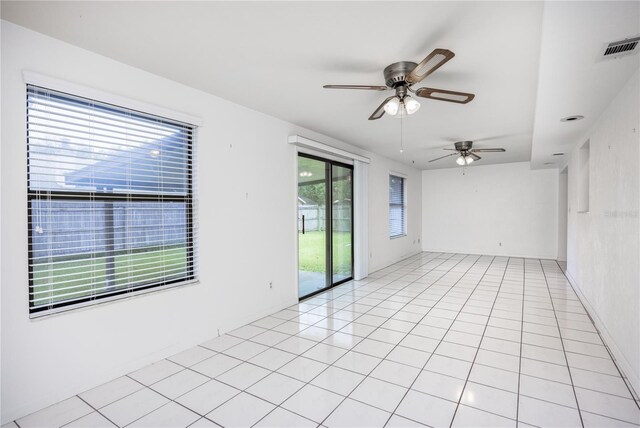 unfurnished room with ceiling fan and light tile patterned floors