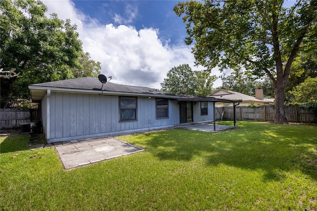 rear view of house with a patio area, a lawn, and cooling unit