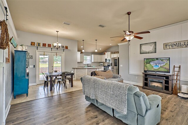 living room featuring a fireplace, plenty of natural light, hardwood / wood-style flooring, and ceiling fan