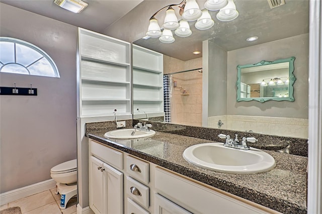 bathroom with tile patterned floors, toilet, curtained shower, and vanity