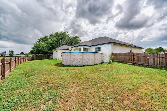 view of yard with a fenced in pool and a fenced backyard