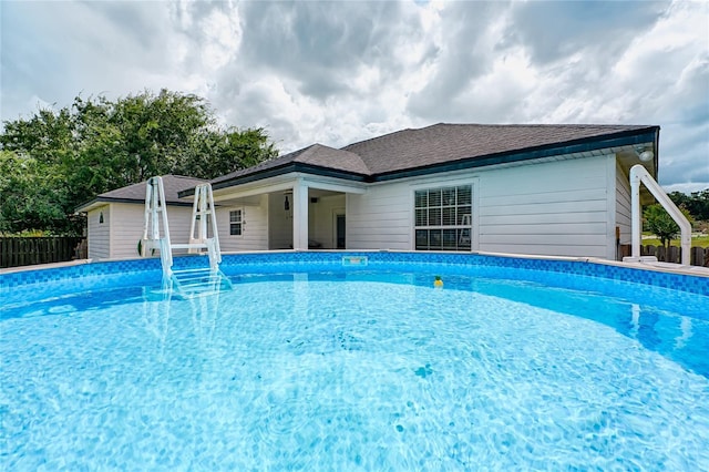 view of swimming pool with a fenced in pool and fence
