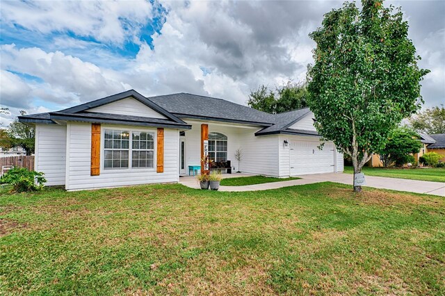 single story home featuring a front lawn, driveway, a shingled roof, and an attached garage