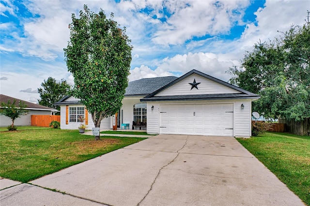 ranch-style home with a front yard, concrete driveway, fence, and an attached garage